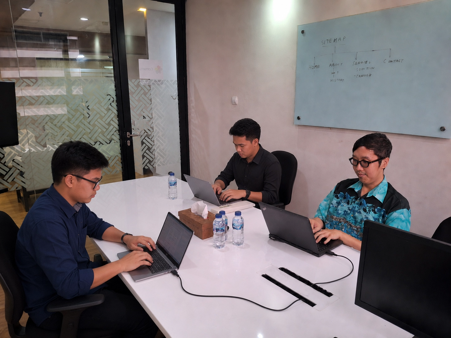 Canvasweb team consulting with a client in the Jakarta studio